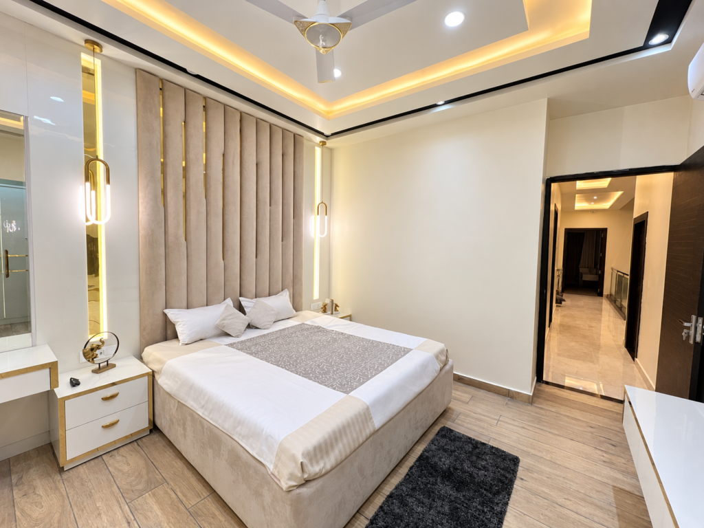 Bedroom with white bedding gold wall detail, Hind Nagar, Kanpur Road, Lucknow