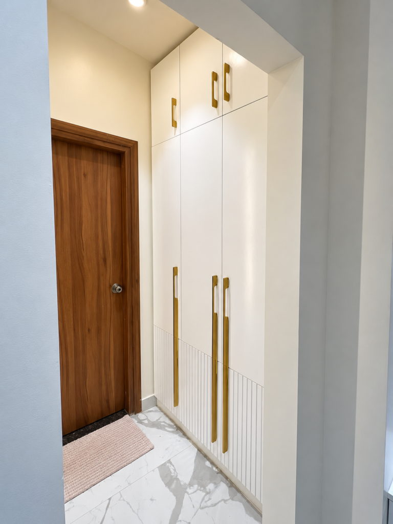 Entryway with white wardrobe gold handles, Vrindavan Yojna, Lucknow