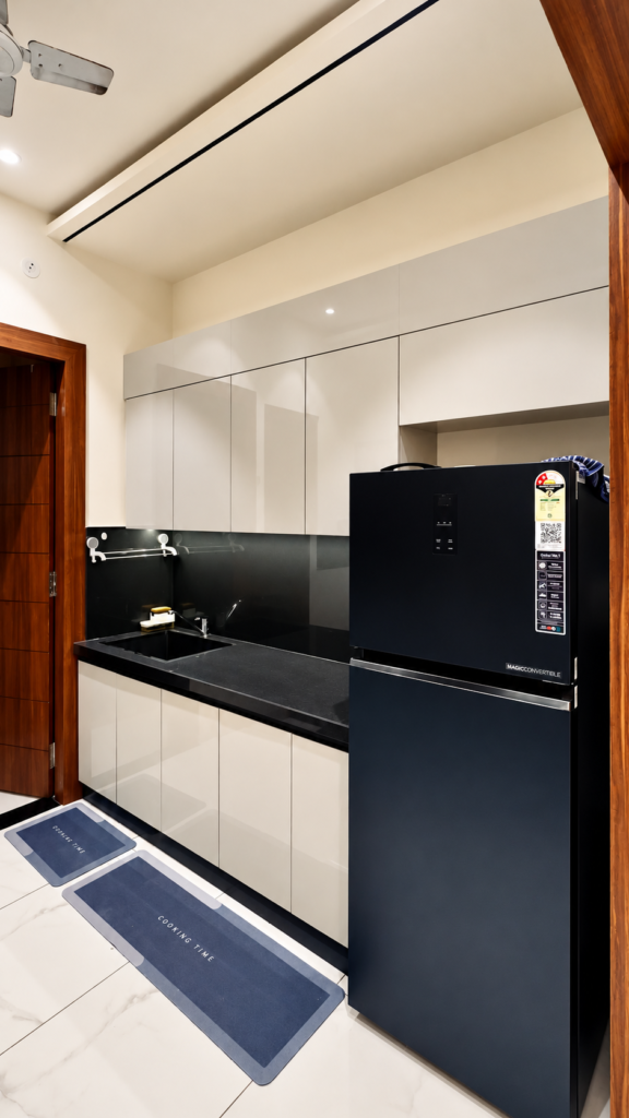 Modular kitchen with black refrigerator white cabinets, Ashiyana Colony, Lucknow
