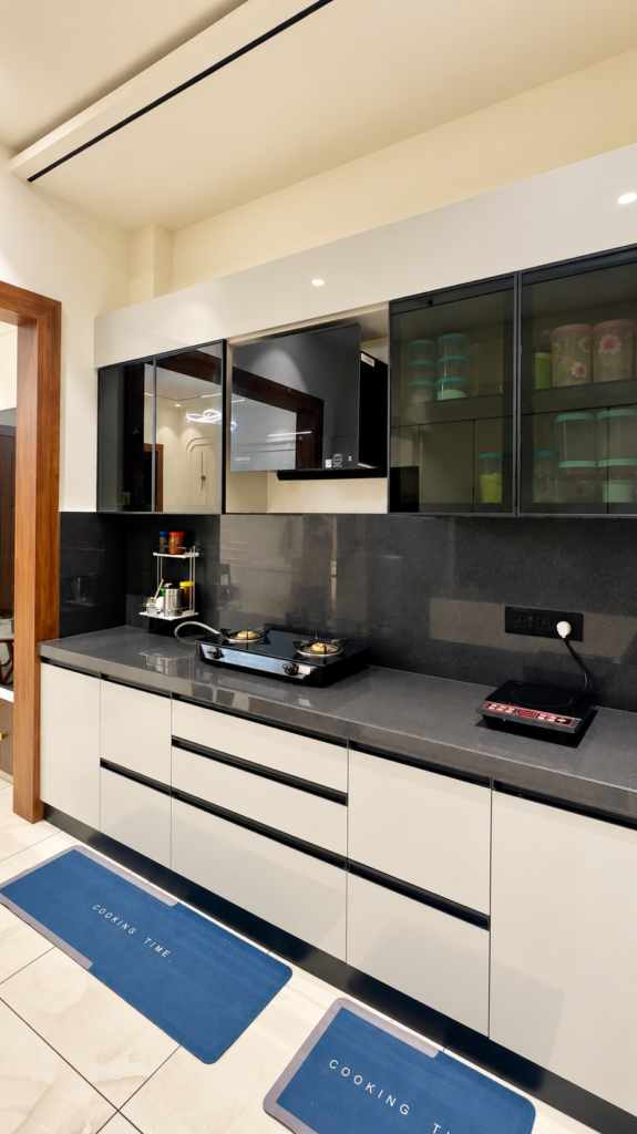 Modular kitchen with white cabinets black backsplash, Ashiyana Colony, Lucknow